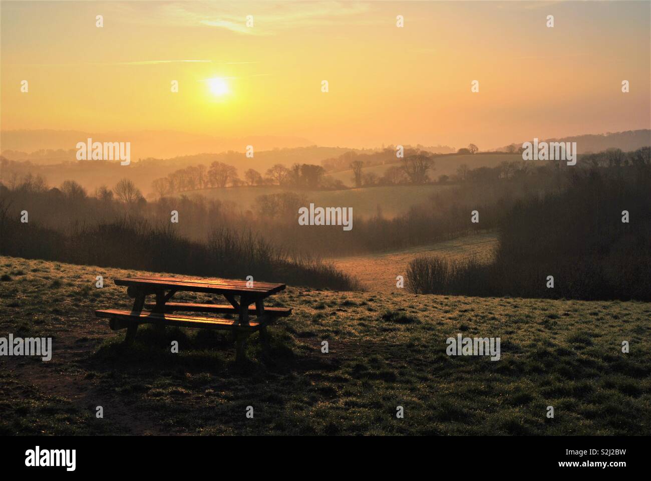 Picnic bench at sunrise Stock Photo