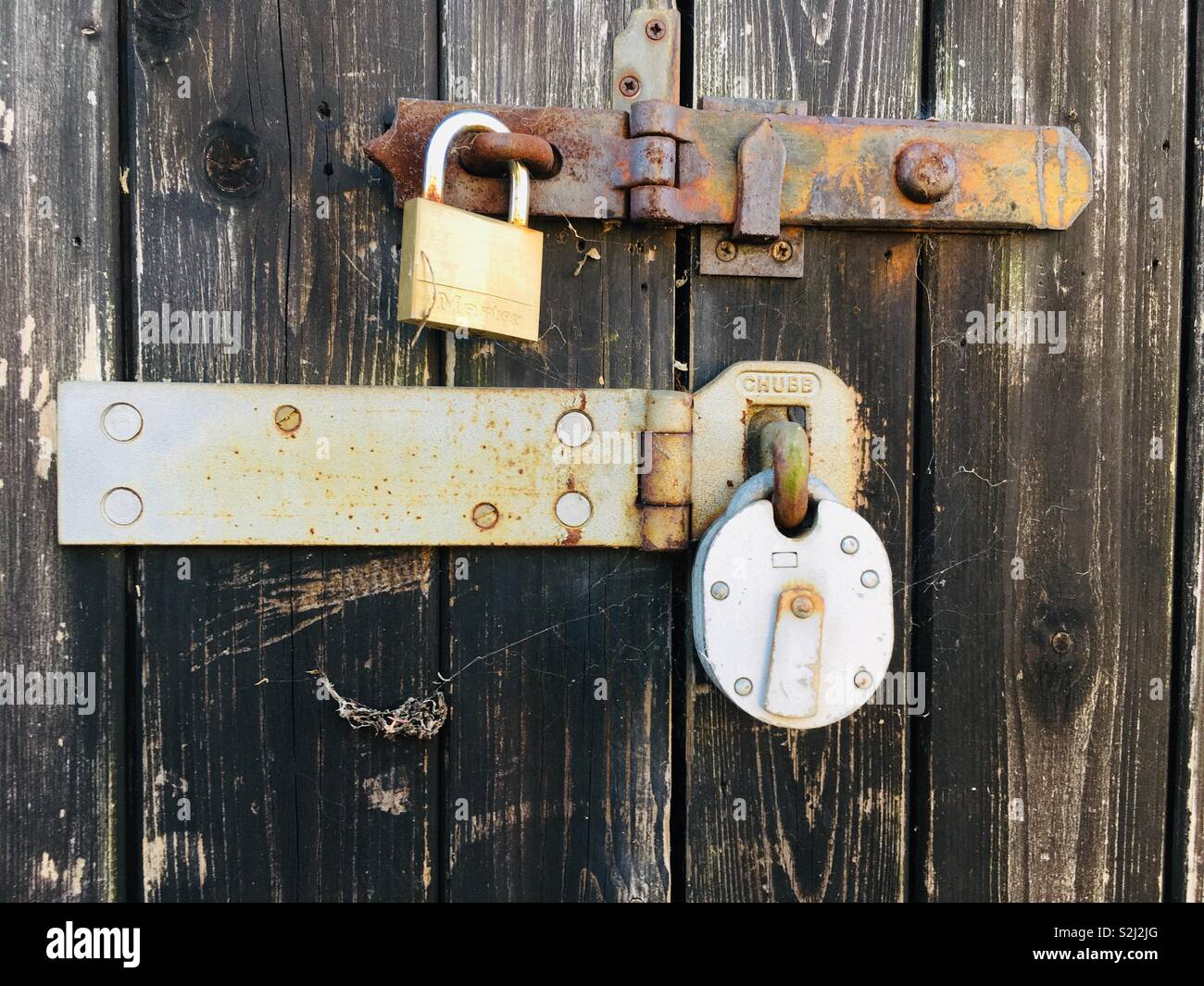 Padlocks on wooden door - Smartphone Captured Stock Image
