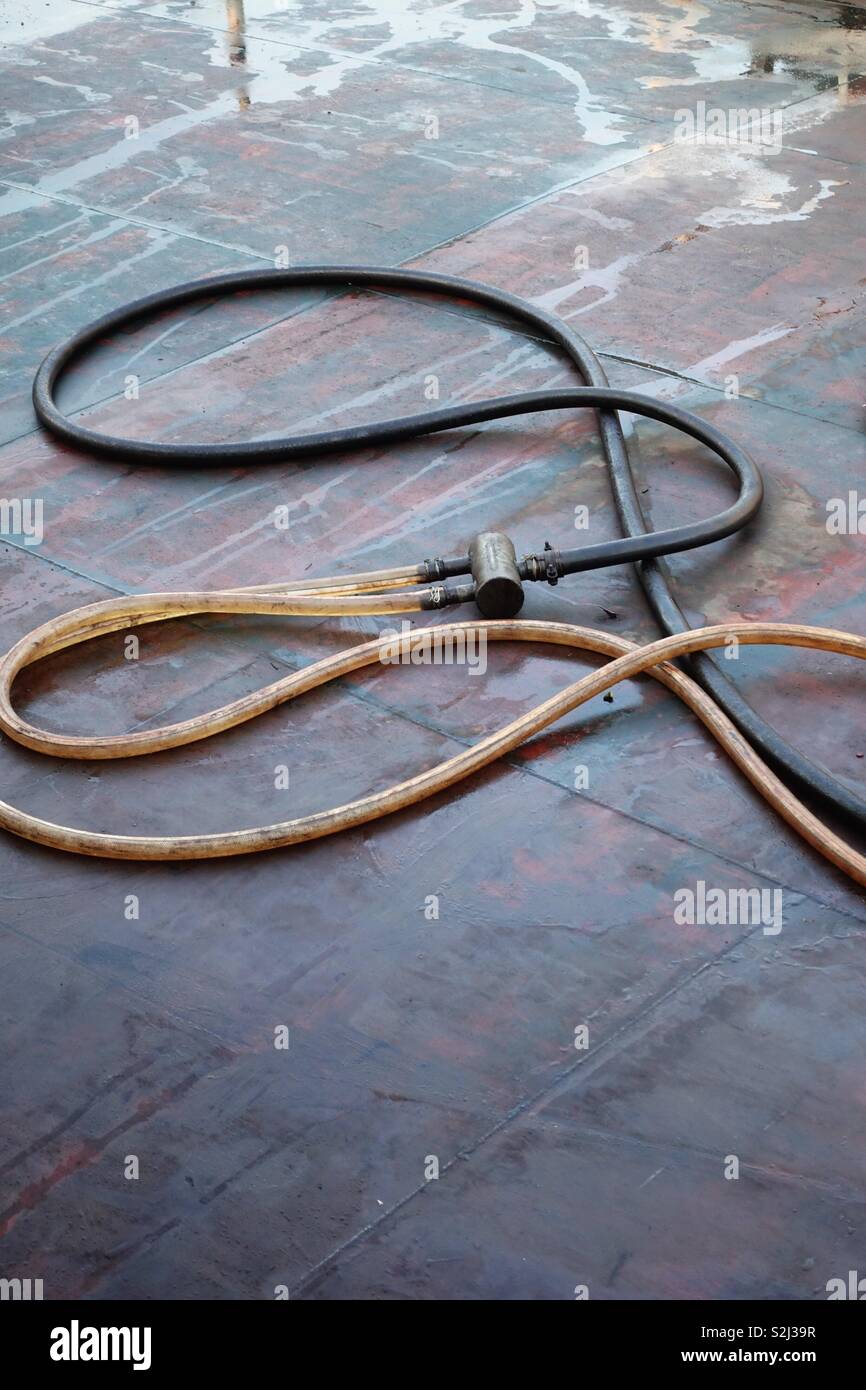 Oily and slippy petrol hoses on deck of a tanker ship. Detail, artful clipping Stock Photo