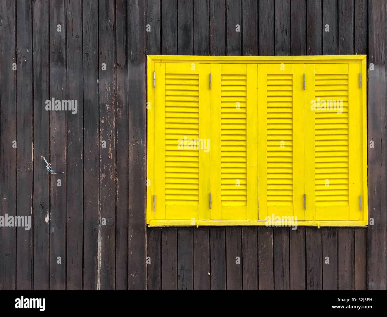 Yellow wooden window shutters - Smartphone Captured Stock Image