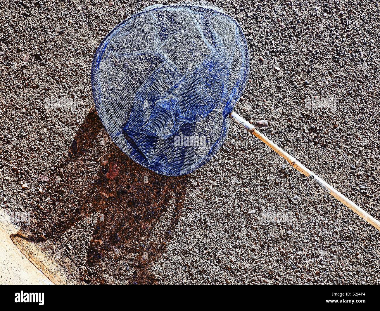Blue child’s fishing net and shadow - Smartphone Captured Stock Image