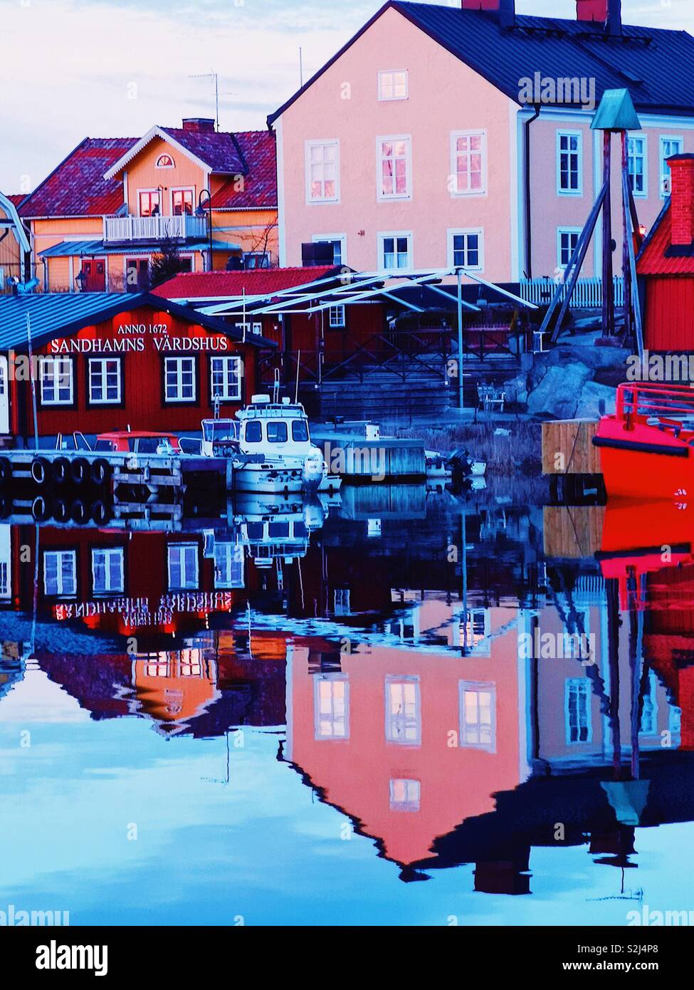 Dusk reflections Sandhamn harbour, Stockholm archipelago, Sweden, Scandinavia. Island in the outer archipelago popular for sailing and yachting since the 19th century - Smartphone Captured Stock Image