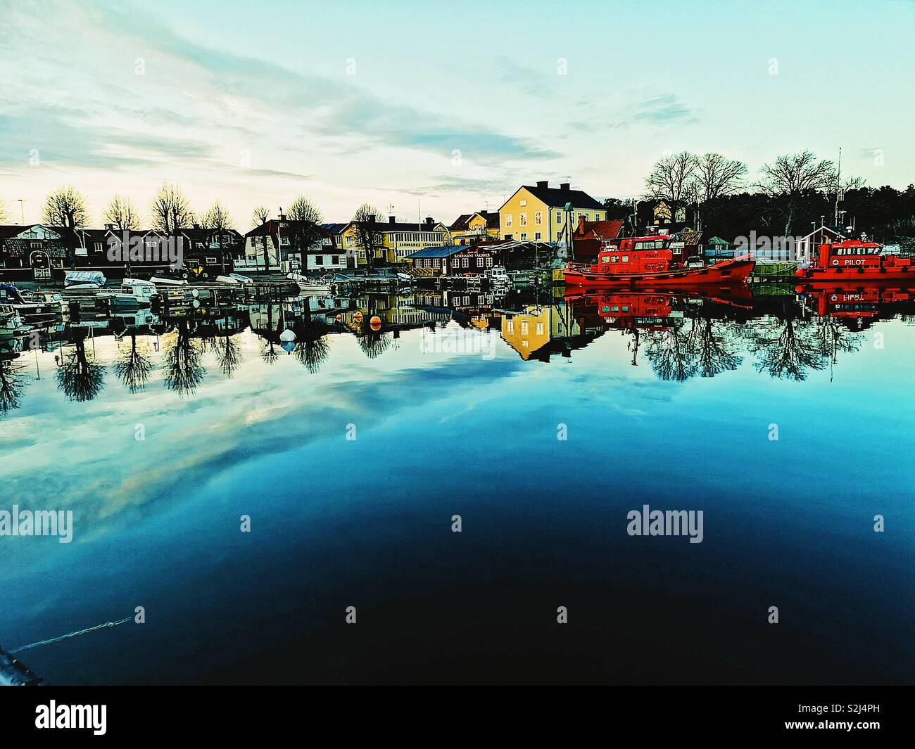 Sandhamn harbour dusk reflection, Sandhamn, Stockholm archipelago, Sweden, Scandinavia. Island in the outer archipelago popular for sailing and yachting since the 19th century - Smartphone Captured Stock Image