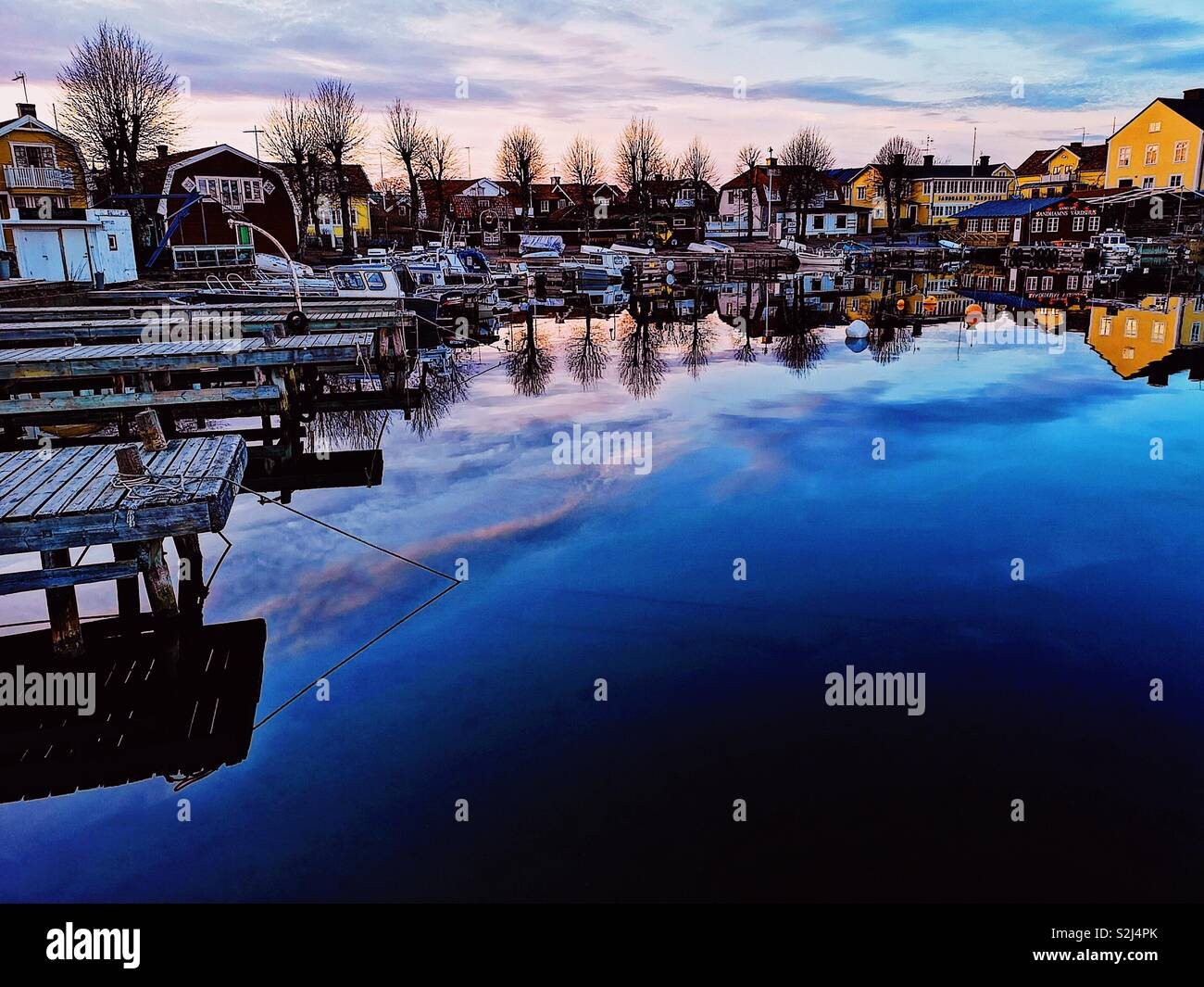 Sandhamn harbour dusk reflection, Sandhamn, Stockholm archipelago, Sweden, Scandinavia. Island in the outer archipelago popular for sailing and yachting since the 19th century - Smartphone Captured Stock Image