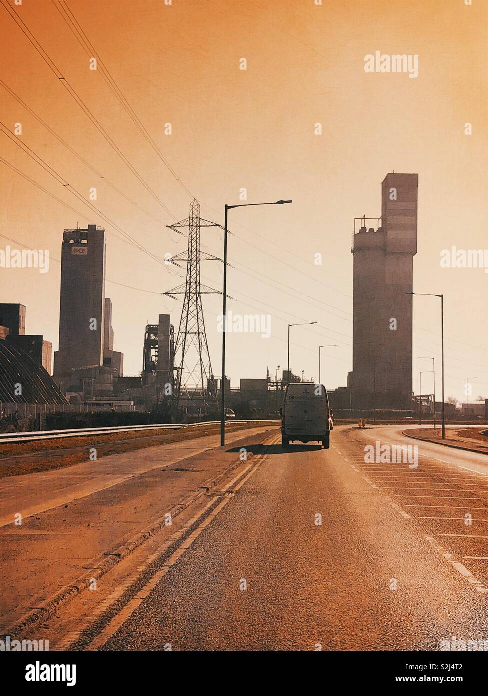 Van travelling along a road through an industrial area on Teeside, UK - Smartphone Captured Stock Image