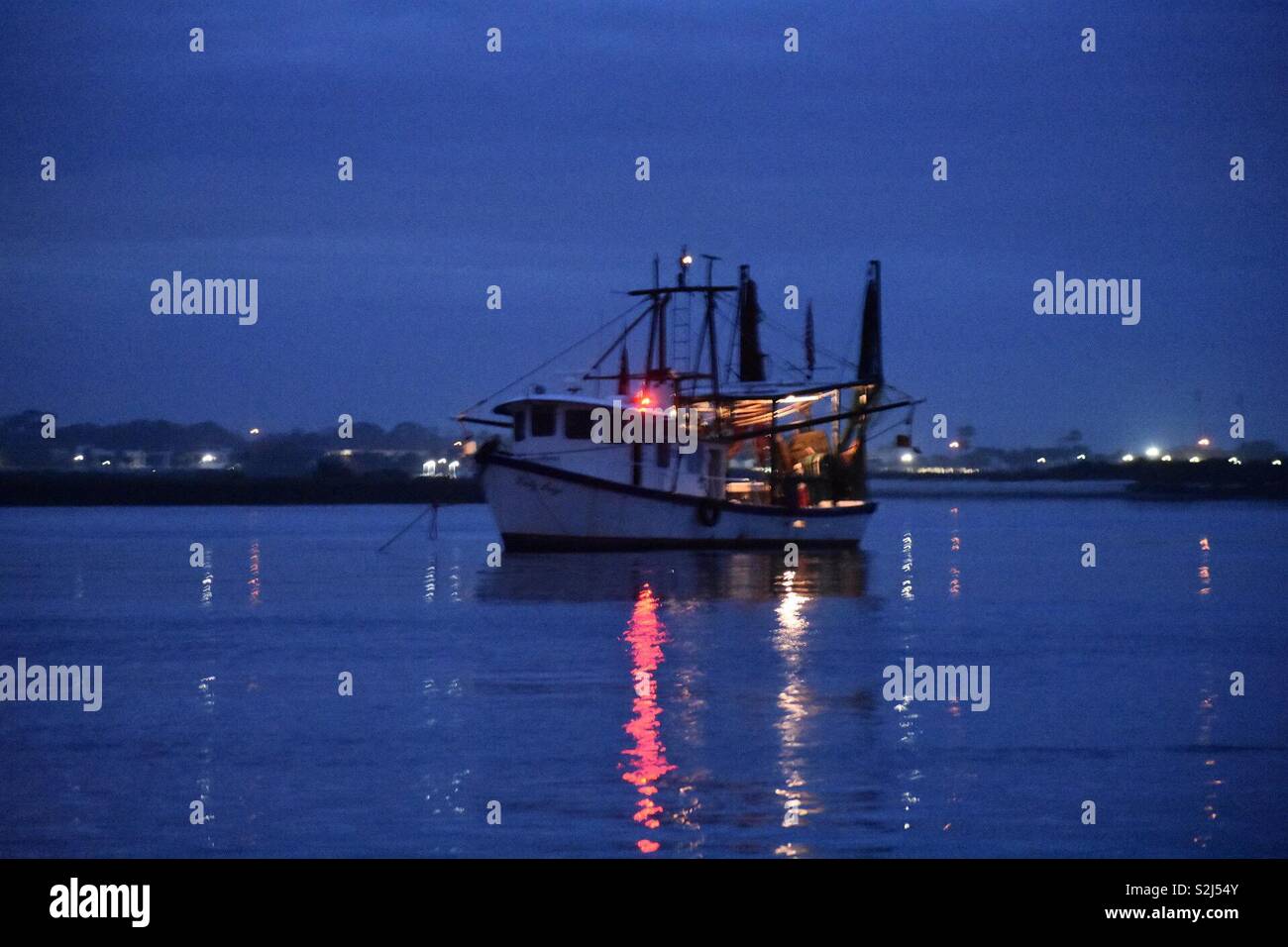Shrimp boat at anchor in the harbor - Smartphone Captured Stock Image
