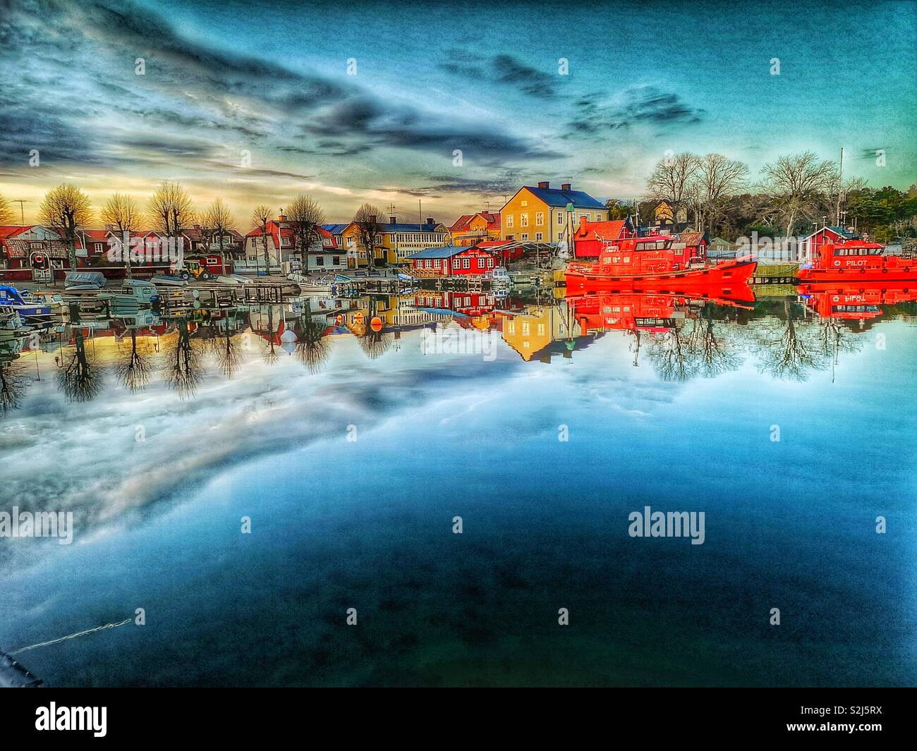 Sandhamn harbour dusk reflection, Sandhamn, Stockholm archipelago, Sweden, Scandinavia. Island in the outer archipelago popular for sailing and yachting since the 19th century - Smartphone Captured Stock Image