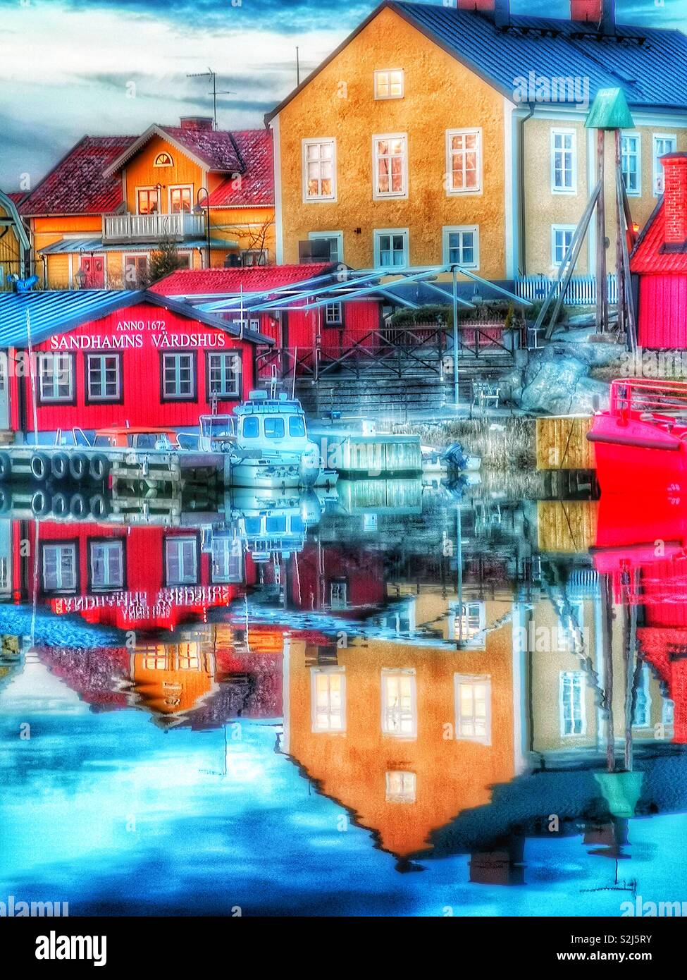 Dusk reflections Sandhamn harbour, Stockholm archipelago, Sweden, Scandinavia. Island in the outer archipelago popular for sailing and yachting since the 19th century - Smartphone Captured Stock Image