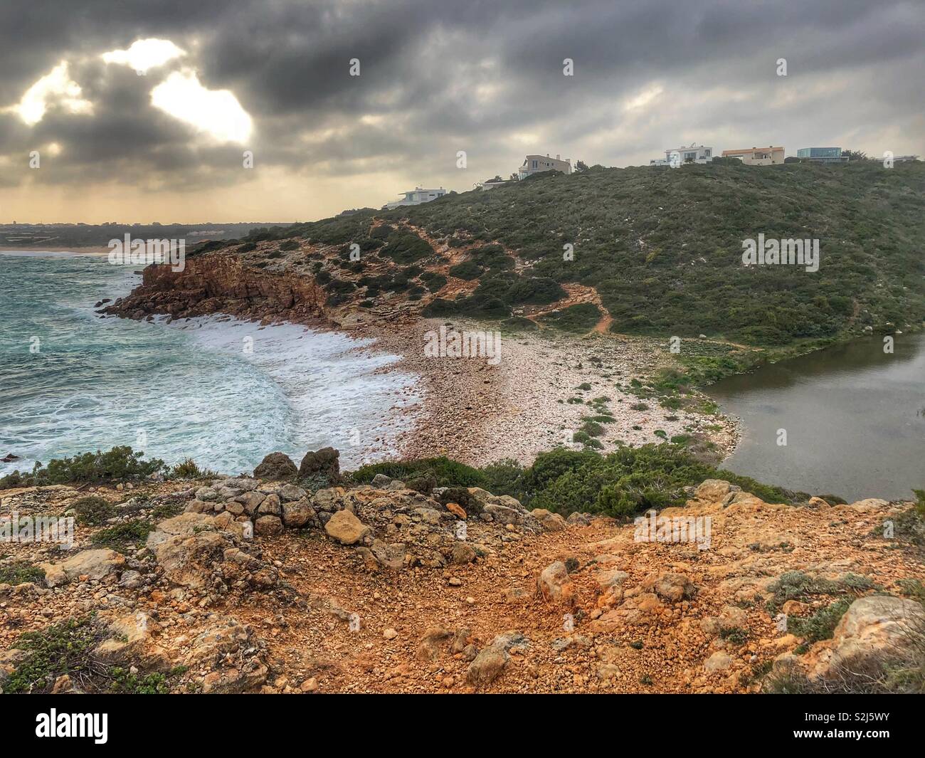 Where the sea meets inland water with pebble beach in between - Smartphone Captured Stock Image