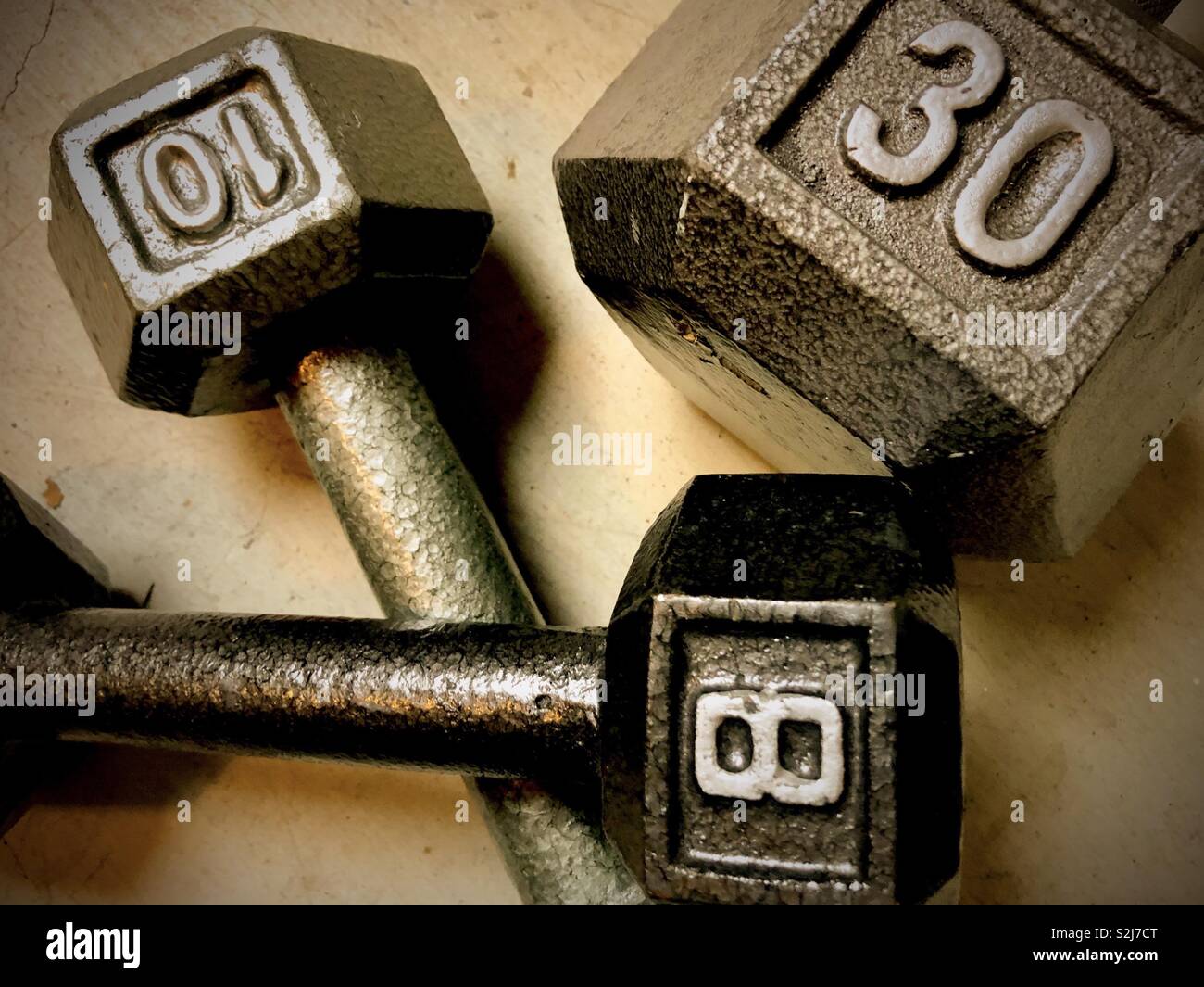 Assortment of dumbbells on concrete floor, top view - Smartphone Captured Stock Image