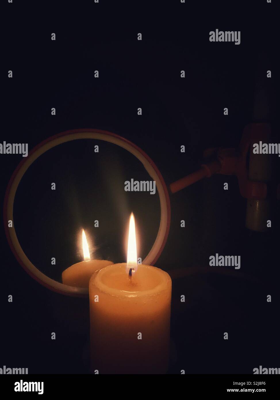 Candlelight reflections on the mirror. - Smartphone Captured Stock Image