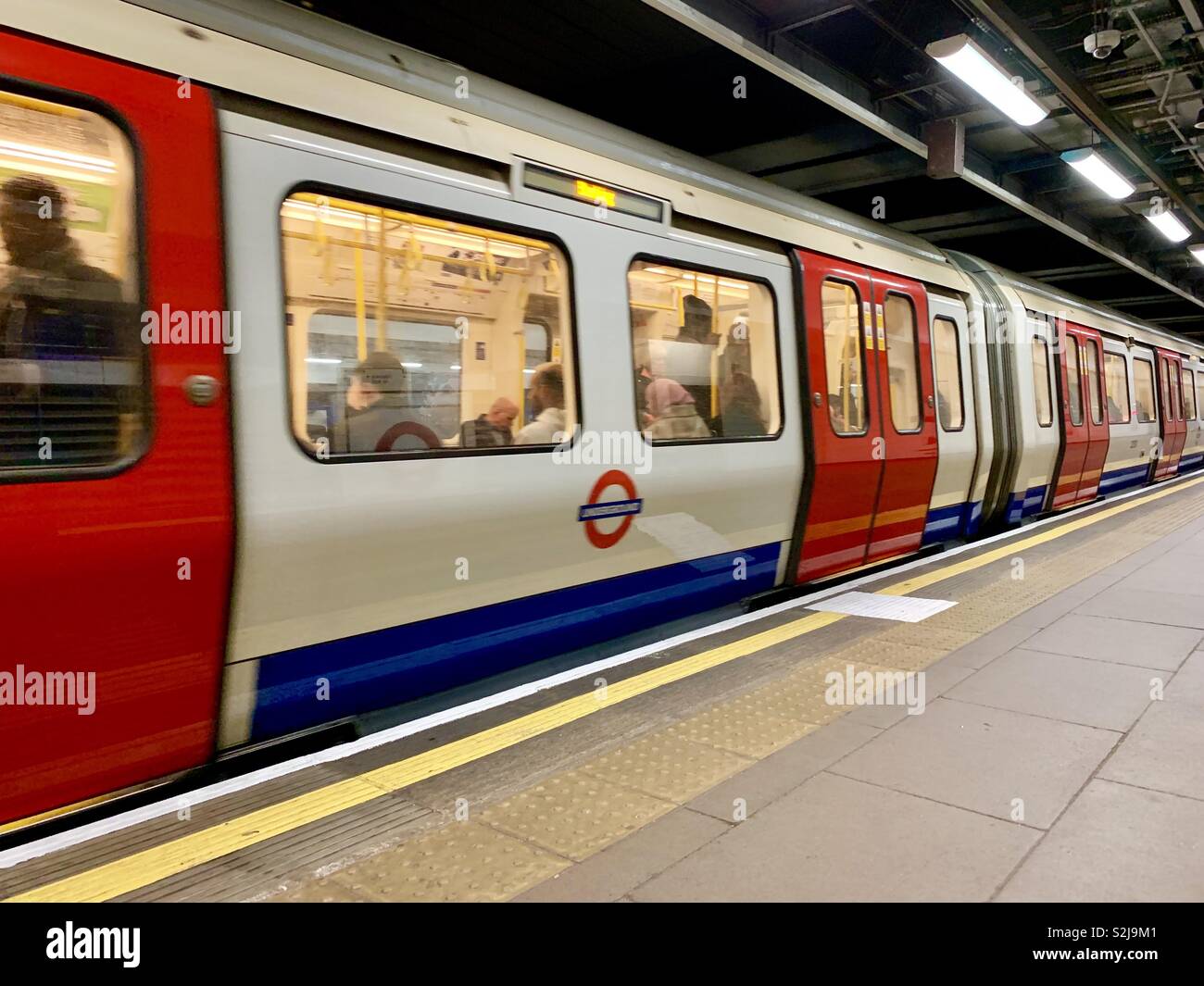 Tube train to Barking setting off from Moorgate underground station. March 2019. - Smartphone Captured Stock Image