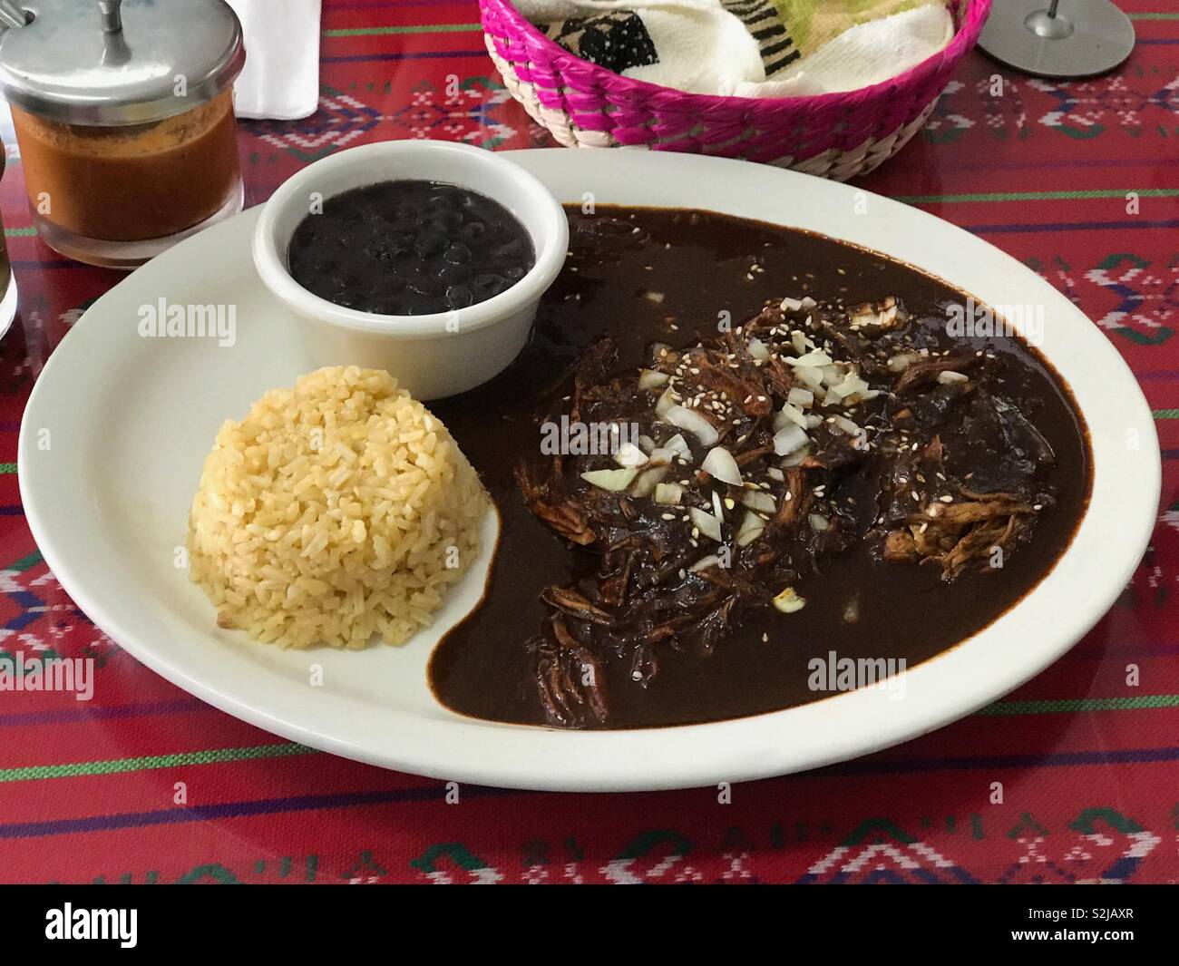 an-entree-plate-of-pollo-con-mole-negro-aka-chicken-with-black-mole