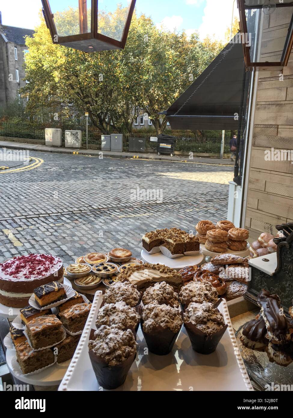 Pastries in coffee shop window Stock Photo Alamy
