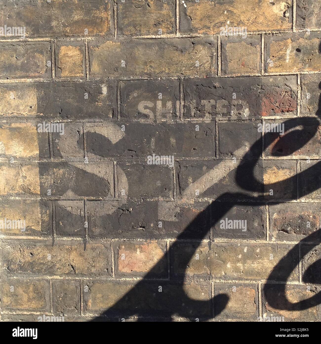 A World War II air raid shelter sign on the wall of a house in central London, England. Stock Photo