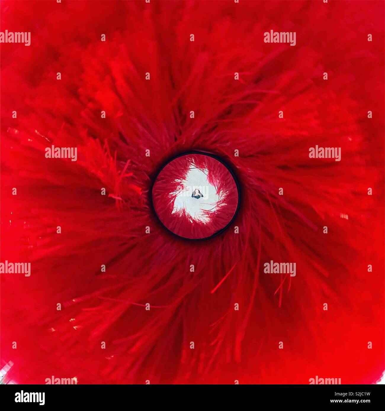 Woman taking a selfie under a red blow-driven rotating object. M9 Area, Mestre, Italy. - Smartphone Captured Stock Image