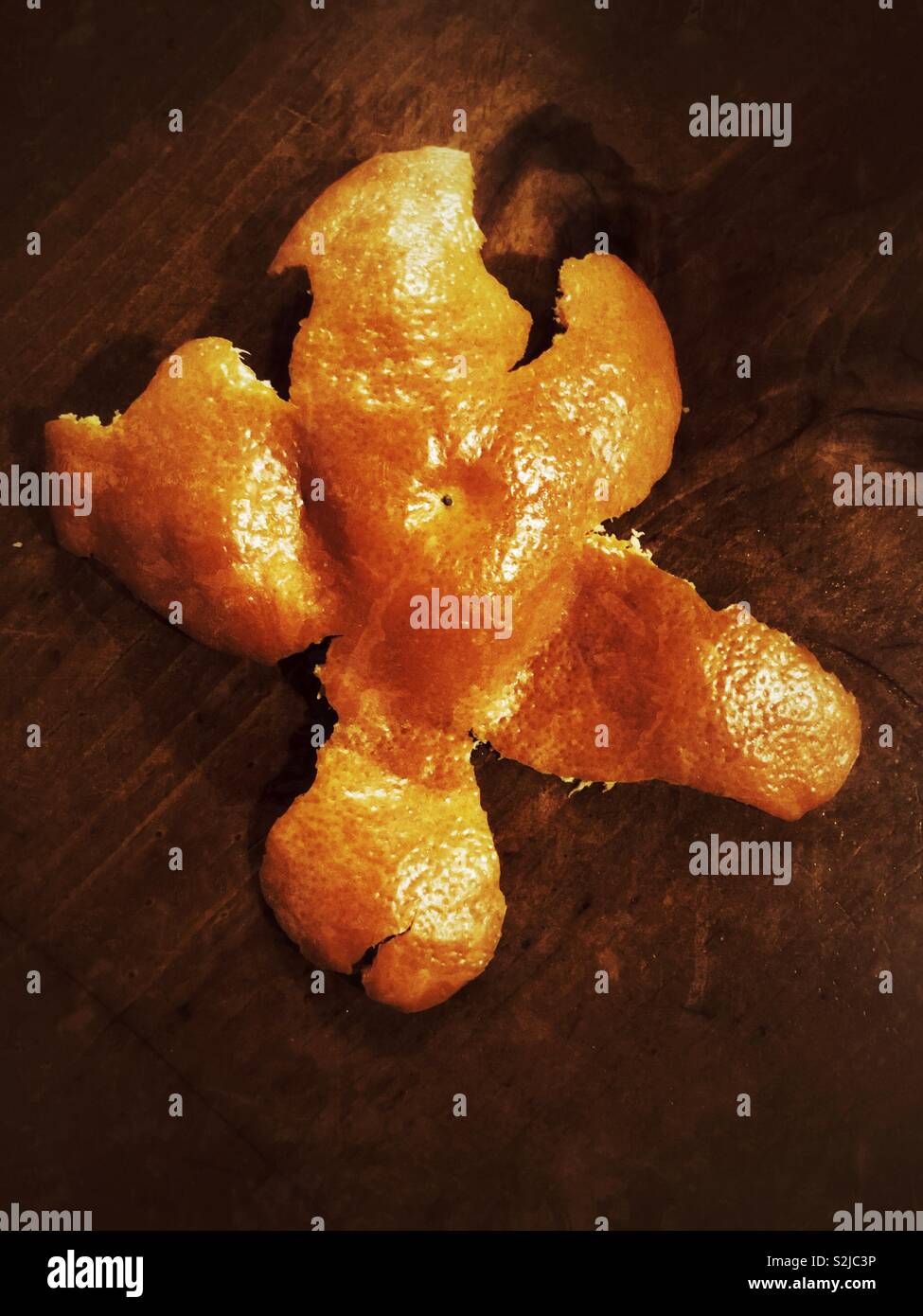 Grunge effect photo of starfish shaped tangerine peeling Stock Photo