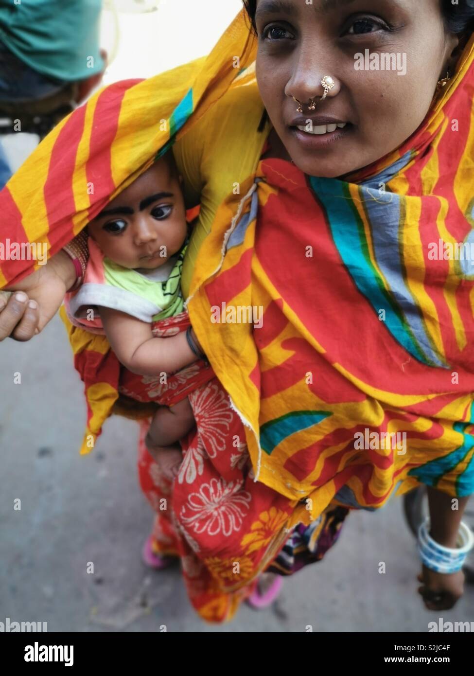 A Bangladeshi woman with her baby. - Smartphone Captured Stock Image