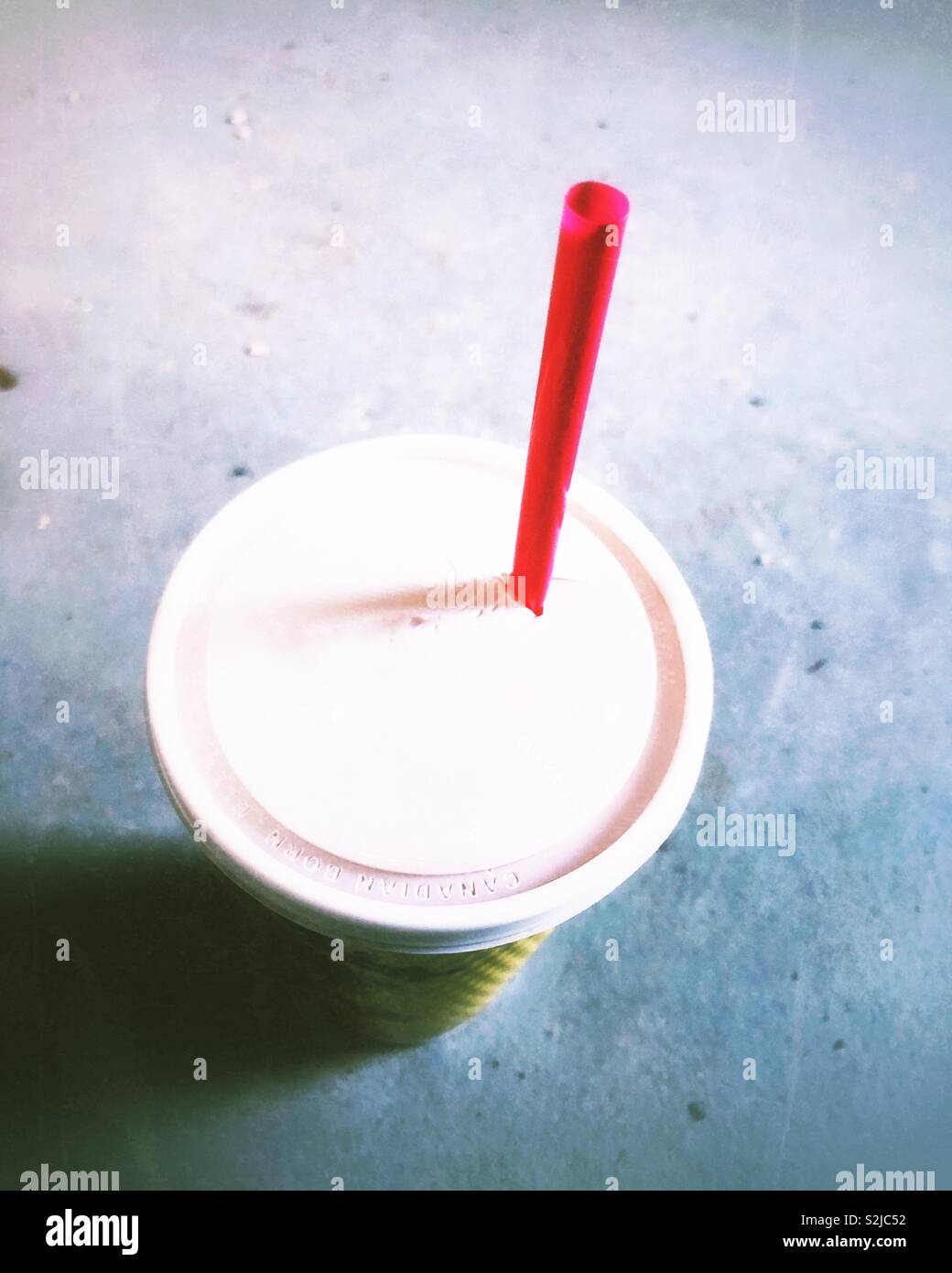 Red plastic straw in plastic takeout cup - Smartphone Captured Stock Image