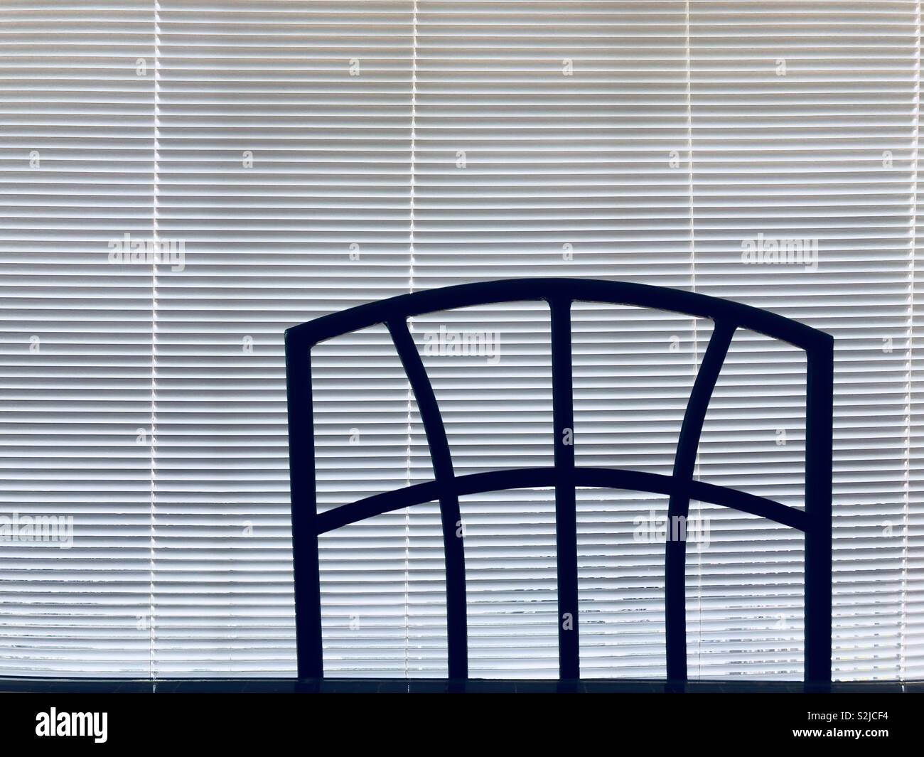 Back of chair against Venetian blinds - Smartphone Captured Stock Image