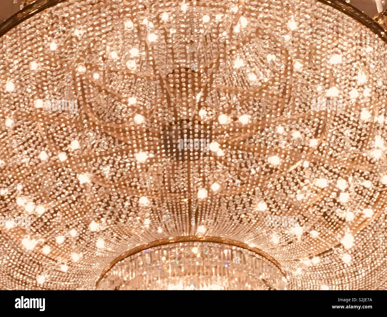 Closeup of a huge glowing and sparkling chandelier with all sorts of ...