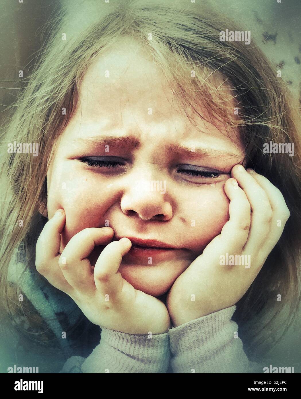 Sad crying girl with hands on face Stock Photo - Alamy