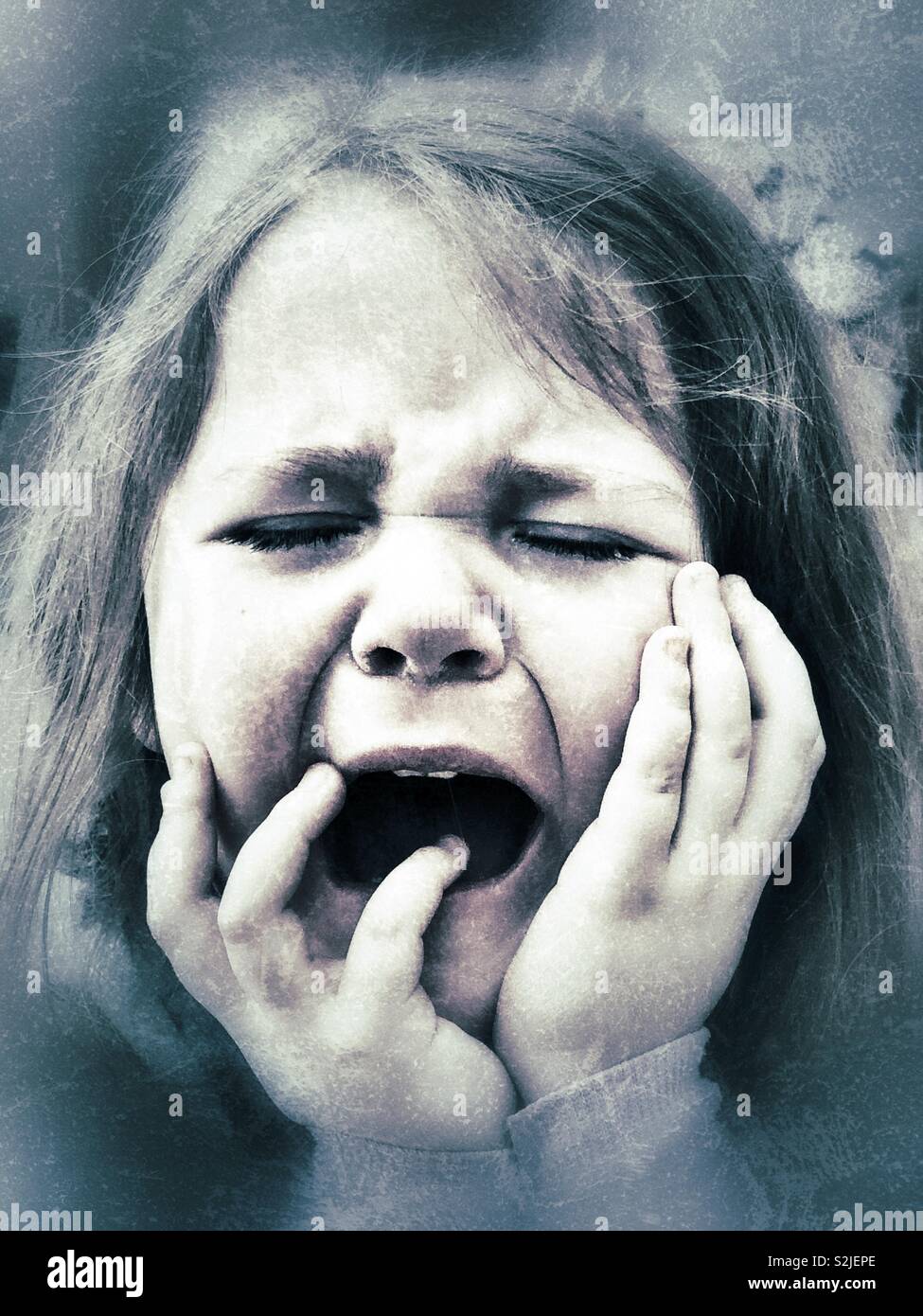 Closeup creative portrait of screaming and crying young girl Stock Photo