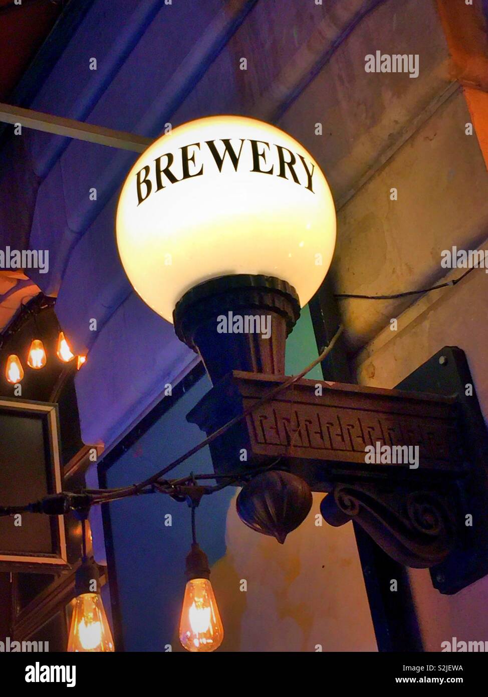 Old style electric globe light at the heartland brewery restaurant, Times Square , NYC, USA - Smartphone Captured Stock Image