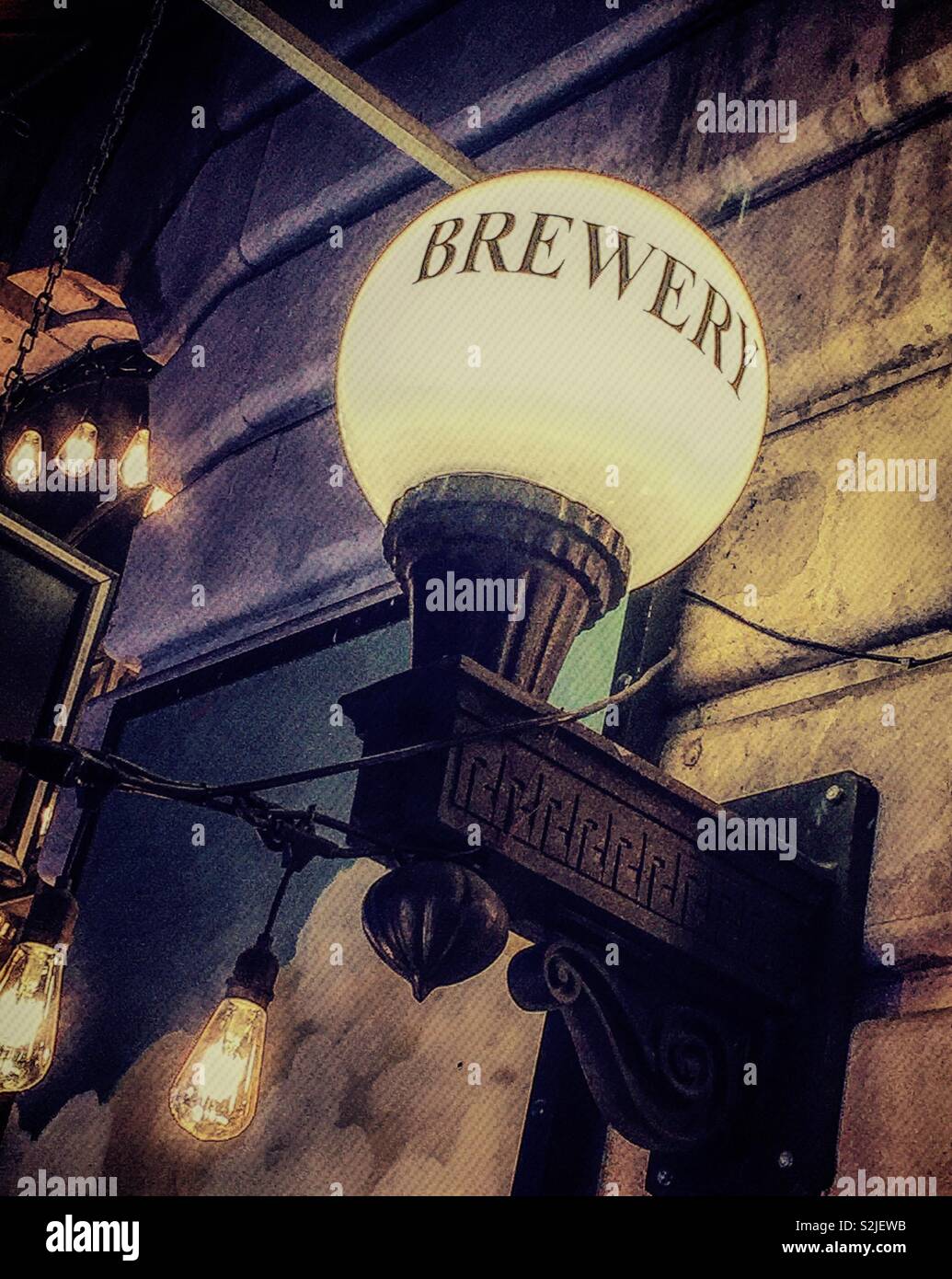 Old style electric globe lamp at the heartland brewery restaurant in Times Square, New York City, USA - Smartphone Captured Stock Image