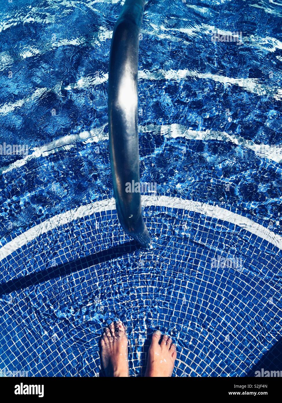 Standing on the pool steps - Smartphone Captured Stock Image Standing on the pool steps - Smartphone Captured Stock Image