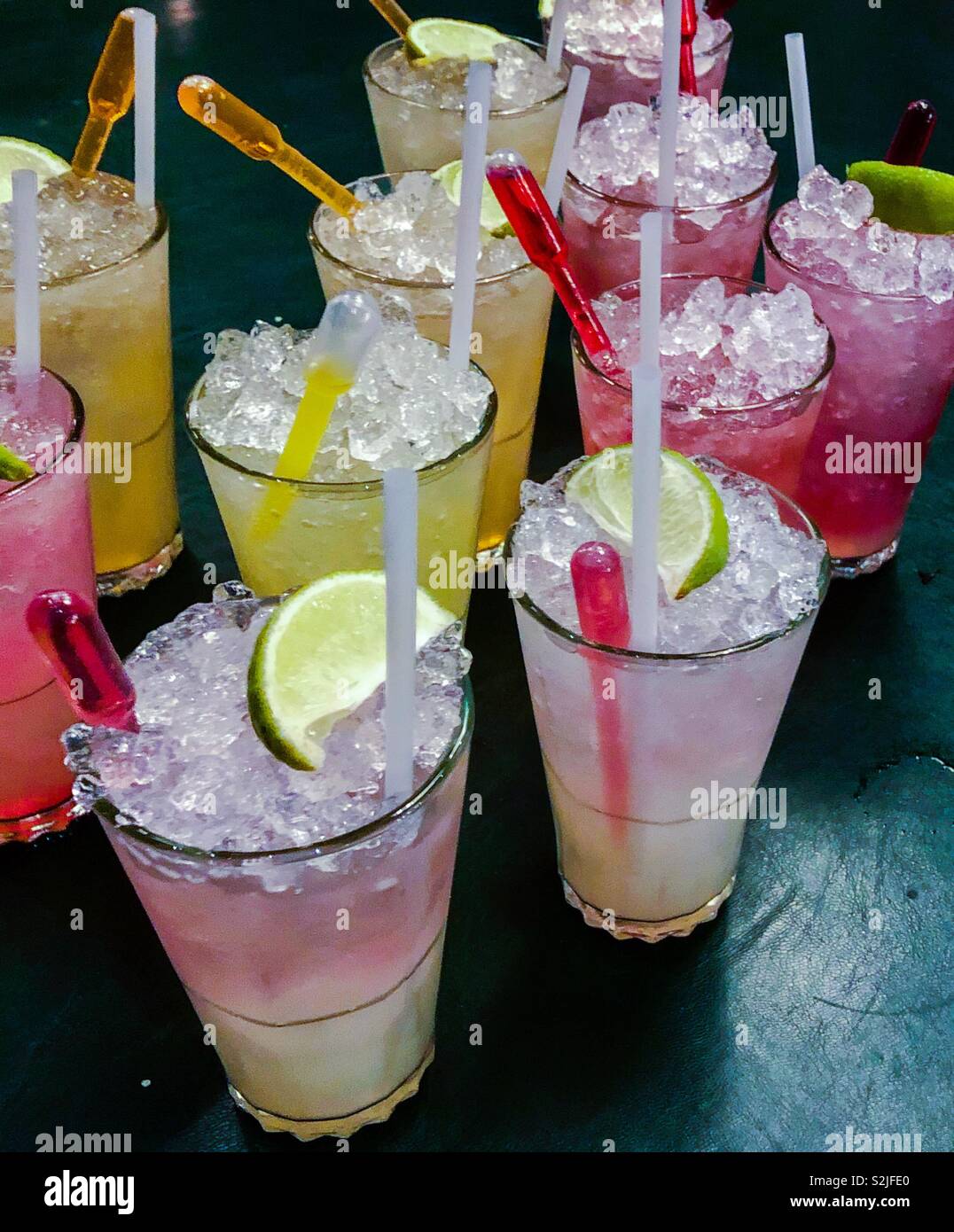 ‘Blank canvas’ cocktails. Vodka, lemon juice, sugar and soda. The dropper in the top of each glass adds a shot of fruit flavour. - Smartphone Captured Stock Image