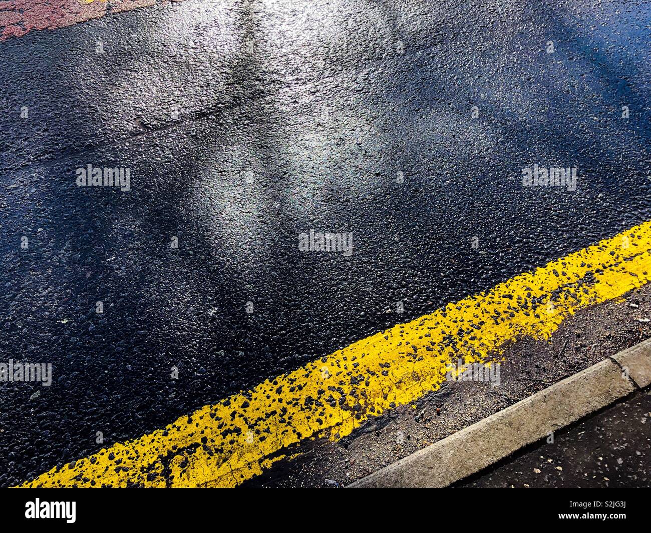 Road markings and tree shadows. Glasgow. Scotland - Smartphone Captured Stock Image