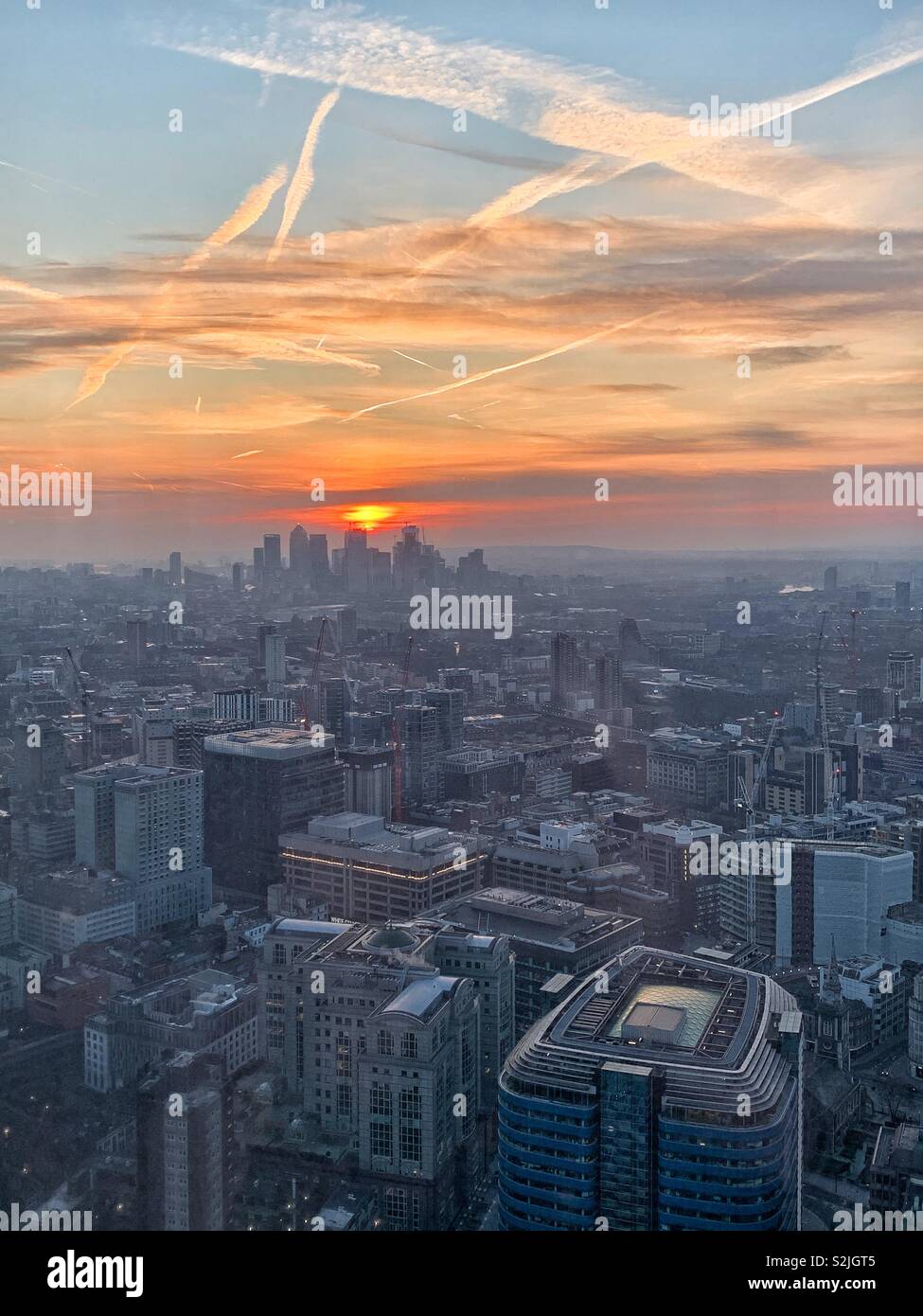 A view of the sun rising on the horizon over London, England. - Smartphone Captured Stock Image