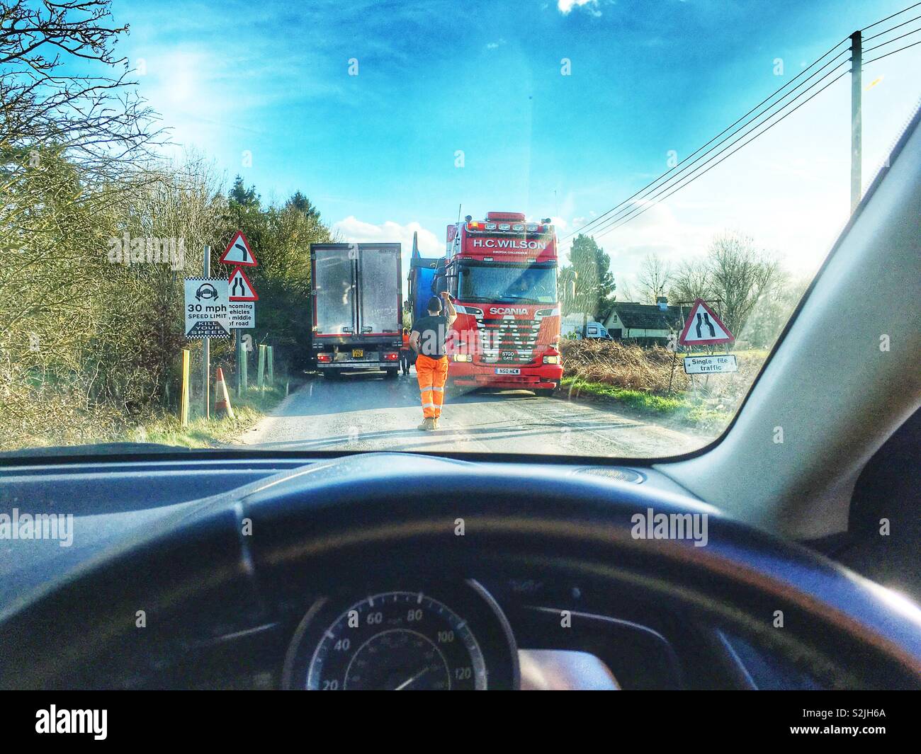 HGV lorries passing on a narrow country road, Shottisham, Suffolk, England. - Smartphone Captured Stock Image