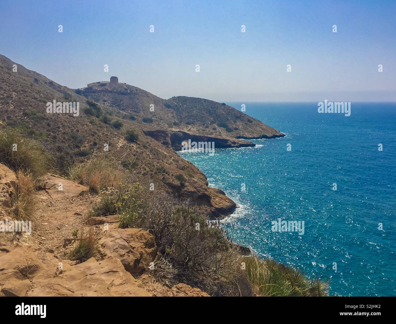 Cliff walk on a hot sunny day in Spain. Stock Photo