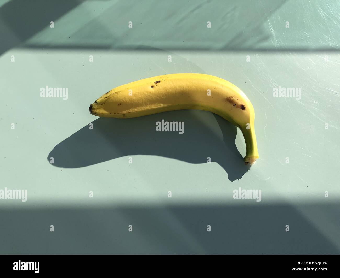 Minimalist image of a single banana - Smartphone Captured Stock Image