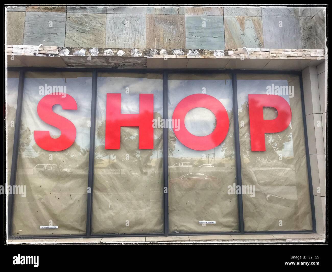 Shop red letters in window display Stock Photo - Alamy