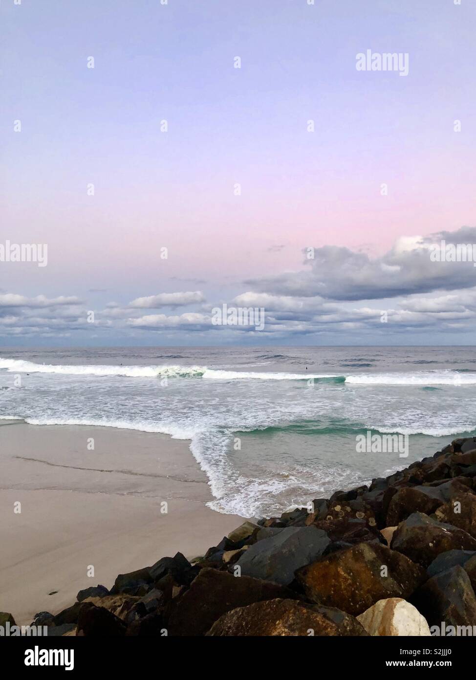 Pink and blue hues over the beach Stock Photo