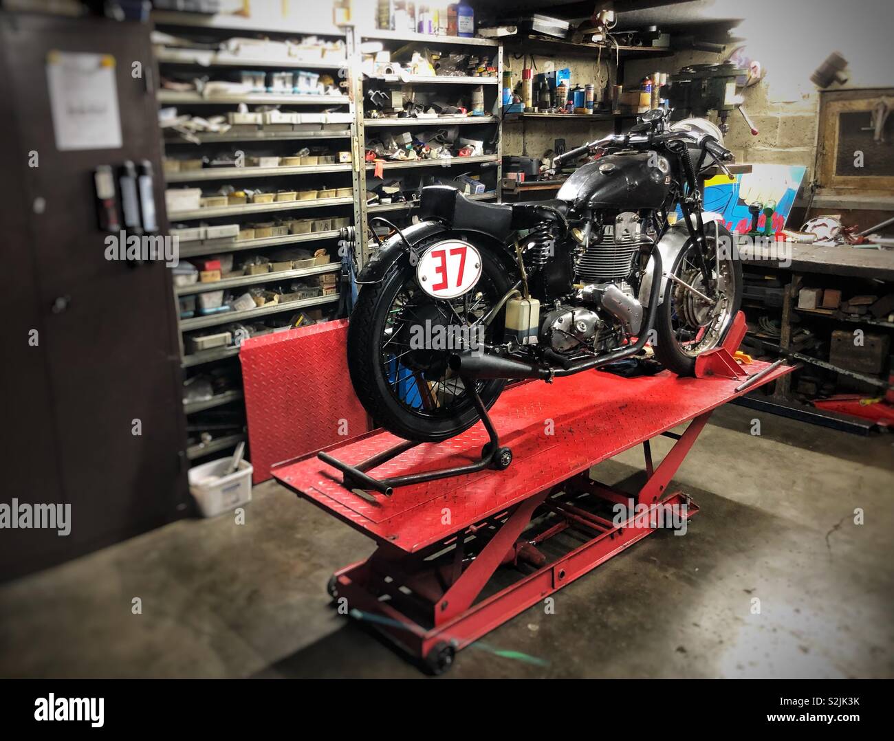 Classic motorcycle in a garage for maintenance Stock Photo - Alamy