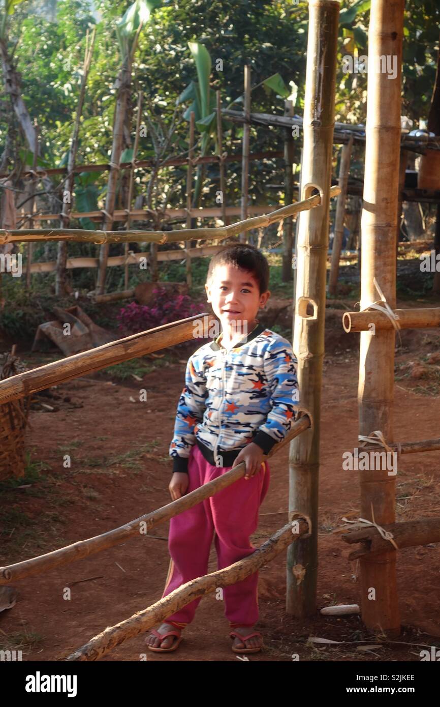Young burmese boy outdoor in the rising morning sun. In his village in Myanmar. Stock Photo