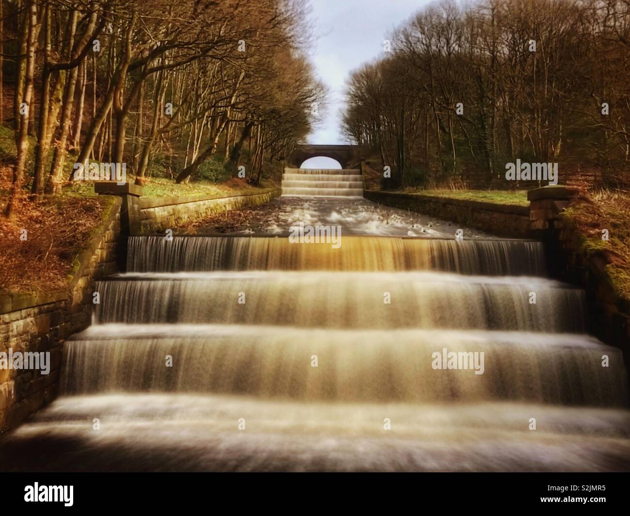Water flowing from reservoir overflow. Overflow from Yarrow reservoir in Rivington, Lancashire - Smartphone Captured Stock Image