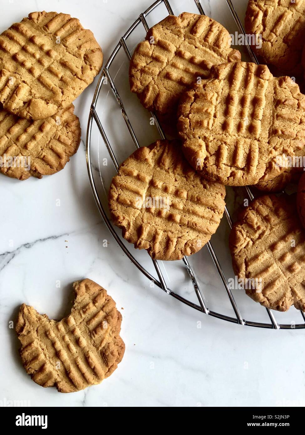Peanut butter cookies on a wire cooling rack Stock Photo