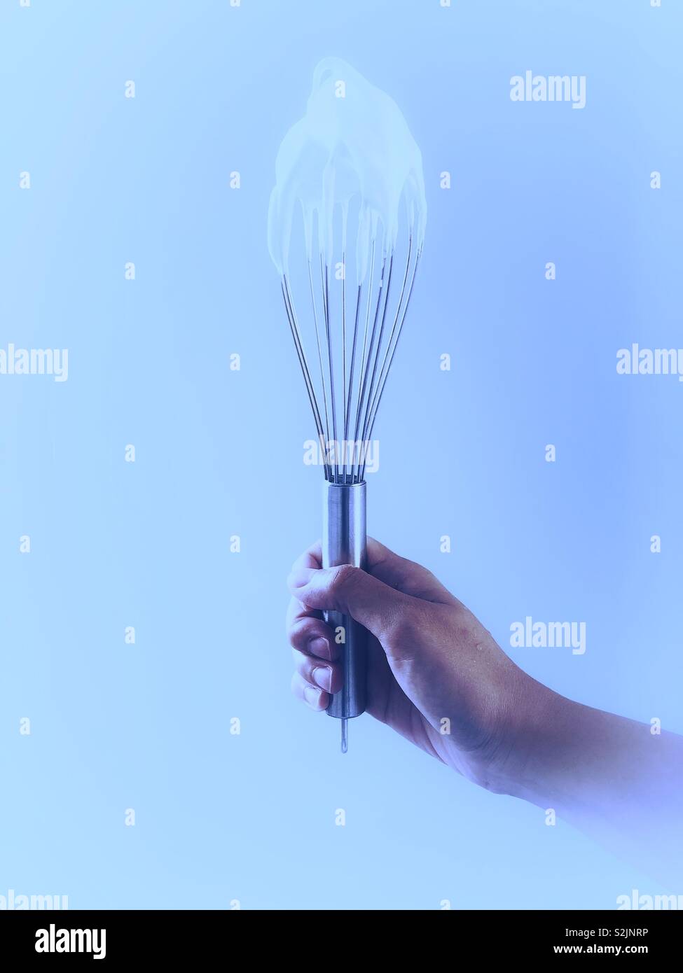 A whisk covered in cream - Smartphone Captured Stock Image