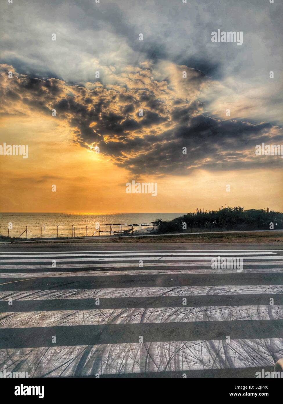A runway next to the sea at Santa Marta airport in Colombia. - Smartphone Captured Stock Image