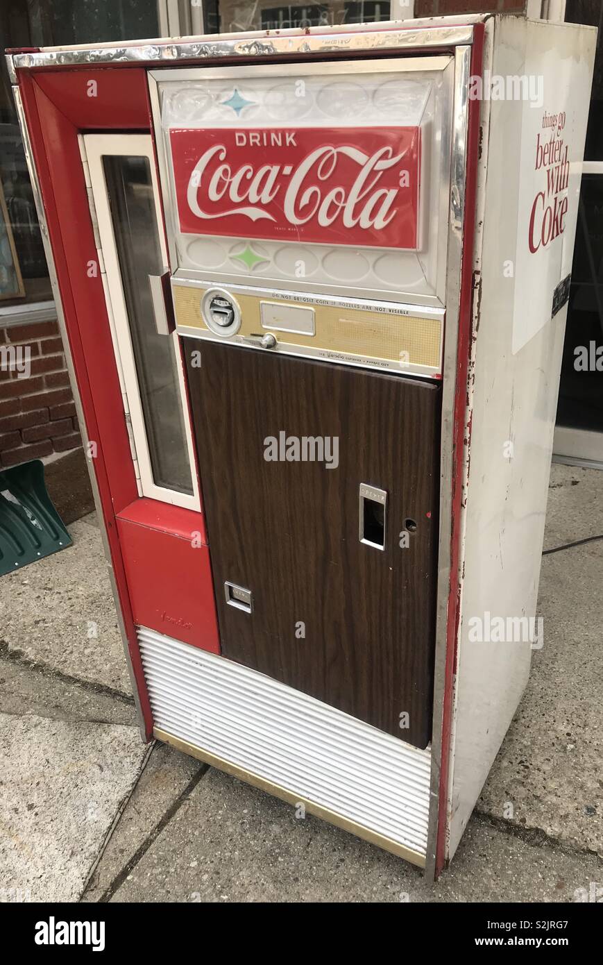 Vintage Coca-Cola Soda Machine at antique store. Stock Photo