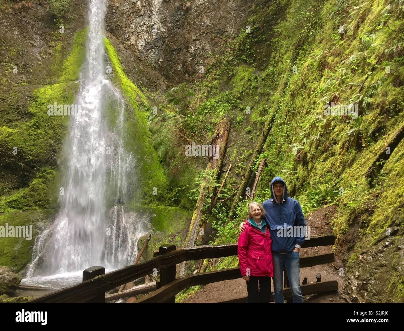 Mother and son posing in front of waterfall, Olympic National park, Washington Stock Photo