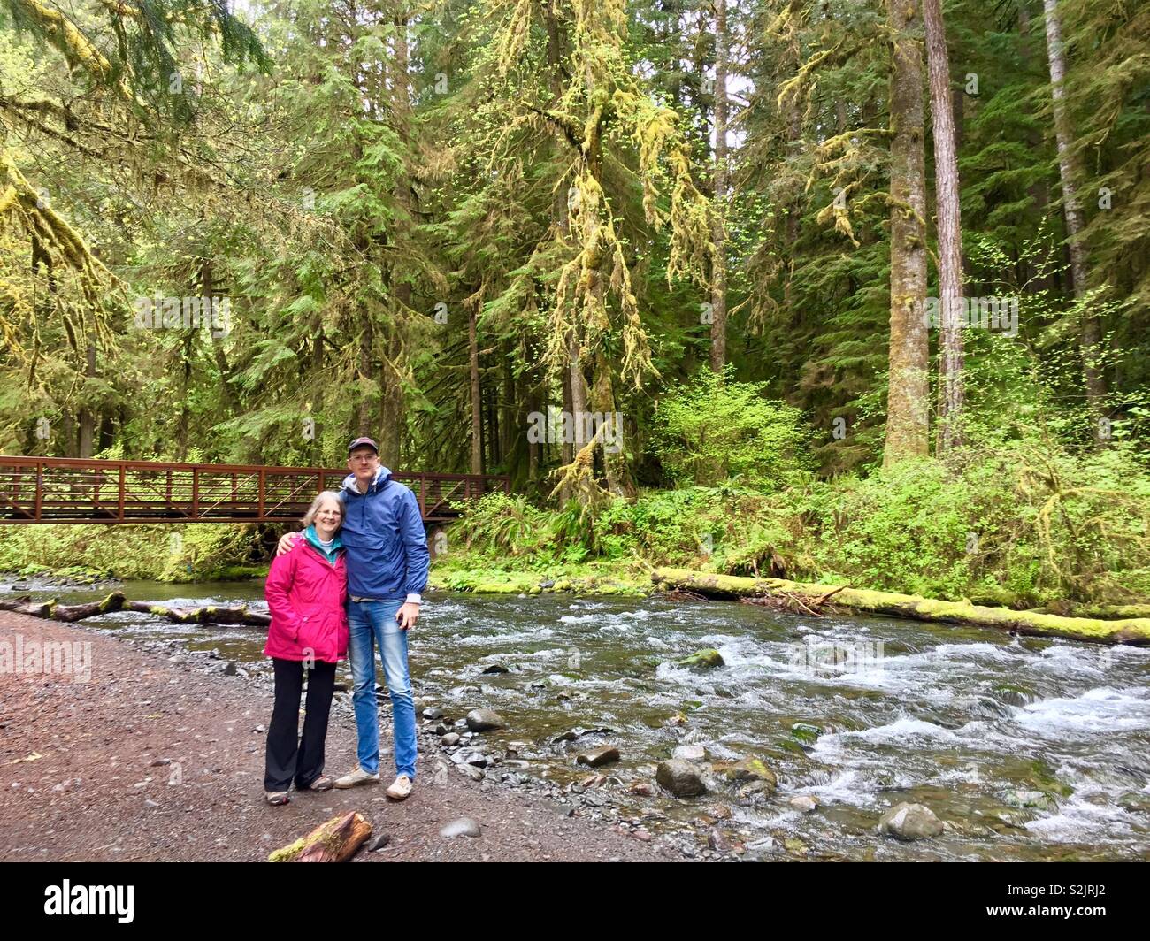 Man and woman posing in front of stream, Olympic national park, Washington Stock Photo