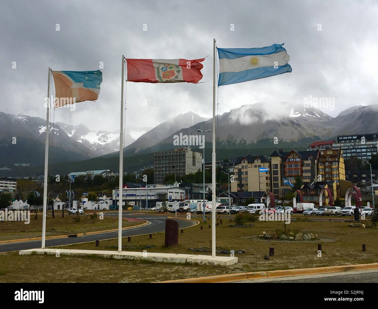 Town Ushuaia with Argentina, Fireland and city flag. Tierra del Fuego, Argentina. Stock Photo
