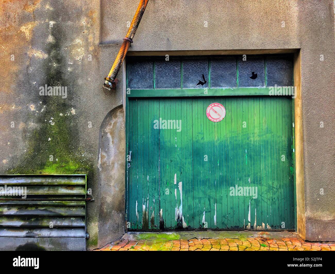 Old Green Garage Door In A French Backstreet Stock Photo