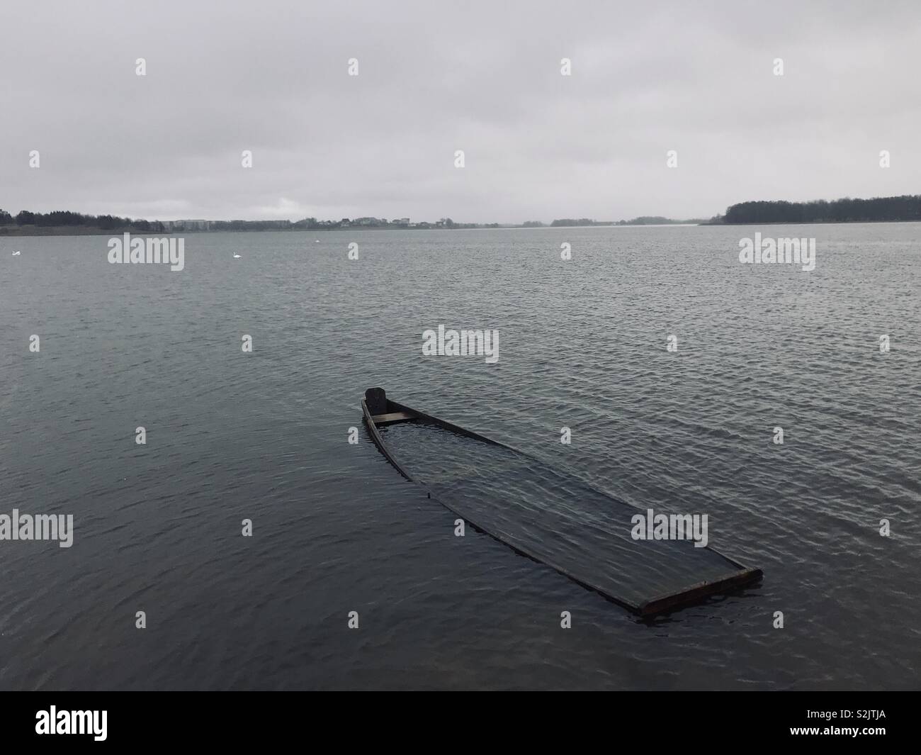 Sunken Boat in Mastis Lake on a cloudy day. Telsiai, Lithuania Stock Photo